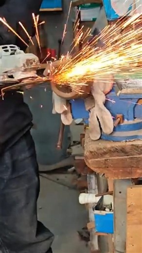 grinding a brown metal manually using a gray machine tool for a very neat craft finishing project