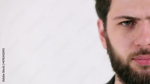 Close-up look of a caucasian man with a beard on white background 4K. Emotions, facial expressions, gesture Stock Video