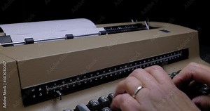 ECU OF FEMALE HANDS USING A VINTAGE ELECTRIC TYPEWRITER. C4K, 10 BIT, ALL-INTRA CODEC
