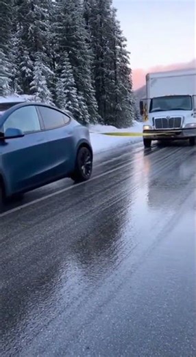 A Tesla pulls a heavy cargo truck forward