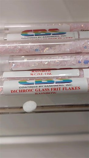 Some brand new bling just arrived! Santa made a brief stop in LA at Coating By Sandberg and whipped up a small short run of Rainbow 2 coated Sky Blue Frit Flakes, Pink Opal Frit Flakes, and Grape Coarse Frit in cute little tubes, just for us, and you! Best get some, throw it in your kiln, and make some beautiful warm glass art, and warm yourself up huddling up to your kiln during this silly Canadian winter. | Stained Glass Stuff