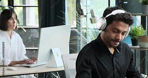 Employee utilizes a computer for a video call in the office. Their focus on effective communication highlights the role of technology in facilitating collaboration and teamwork.