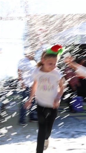 Operation Whoville, Through a Child’s Eyes 💚 Laughter pulled families toward the CPLC Community Center, where the Grinch waited patiently for photos. Kids shuffled forward in line, practicing poses, whispering ideas, deciding how close they would stand. When their turn came, smiles broke wide , the kind that doesn’t need prompting. Nearby, children ran through the snow again and again, arms out, shoes dusted white, the moment something rare and magical. Just beyond, the Whoville toy shop invite