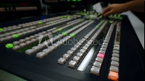 Broadcast Tv Studio Production - Vision Switcher Studio Director broadcast video mixer operation - Close-up of hand. Hands of a cinematographer who worked on the vision mixer, switch the TV panel.