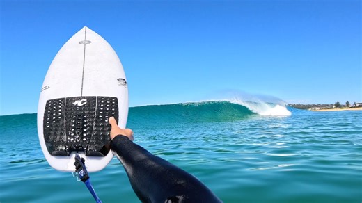 Testing a new surfboard in perfect beach break waves