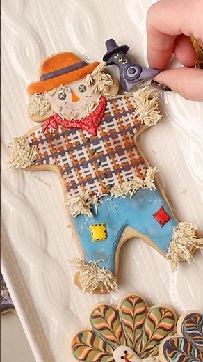 Cute scarecrow cookie with royal icing and shredded wheat cereal