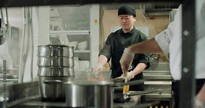 backstage workflow in the kitchen of the restaurant, the team of Asian chefs work with vegetables, cooking vegetarian dishes