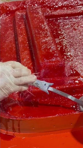 Wetting out this fiberglass layer with resin #NuWaveComposites #HandLayup #Fiberglass