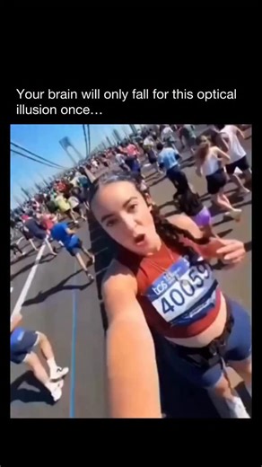 PEEPER on Instagram: "Follow us (@PEEPER) for more! 👀 In this optical illusion, known as induced motion or vection, a stationary woman on a median appears to glide forward like on a conveyor belt due to marathon runners streaming past her in the opposite direction on both sides. The brain relies on relative motion cues: the background (runners) moving backward tricks it into perceiving the foreground (woman) as advancing. This exploits how our visual system prioritizes contextual movement over 