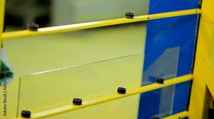 Manual worker assembling PVC doors and windows. Factory for PVC windows and doors production. Production of plastic windows