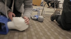 CPR training class by security guard in office