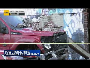 Tow truck crashes into South Shore building, video shows