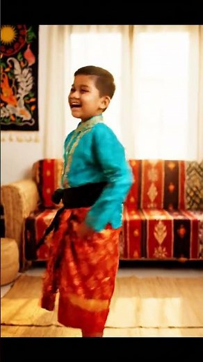 A Boy Kid showing his Malaysian Cultural & Traditional Dress with a folk music