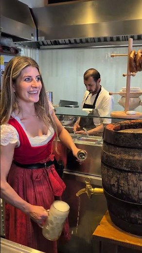 Bavarian Bartender Taps a Wooden Beer Barrel for a Fresh Pour