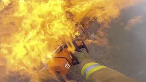 Body-cam video shows firefighters battling a dramatic blaze at a home in Victorville. In the footage, released by the San Bernardino County Fire Department, flames are seen erupting through the roof after chainsaws are used to ventilate the structure. Firefighters searched the house after extinguishing the inferno and found a dog, which was reunited with its displaced owners. Read KTLA's story here: http://ktlane.ws/1DfPZ8x | KTLA 5 News