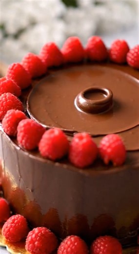 The Viral Chocolate Fudge Cake with Raspberry Ganache There’s something about a tall, glossy chocolate cake that feels like it belongs in the center of the table, waiting to be sliced thick and generous. This Bakery-Style Chocolate Fudge Cake is rich, deeply chocolatey, and finished with a silky ganache that melts right into every bite. With Valentine’s Day here, it’s the kind of dessert that makes everyone linger a little longer at the table. Save this one for someone you love — or tag the choc