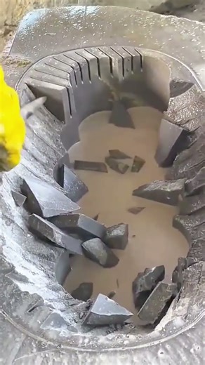 Mixing wet concrete thoroughly inside industrial rotating cement mixer