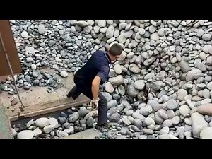 Barge unloading cobblestone - relaxing video,the flow of stones is very fast and smooth relaxing