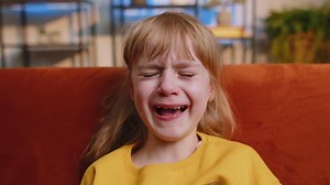 Upset punished offended child girl kid crying with tears at home, quarrel, abuse, bullying, violence