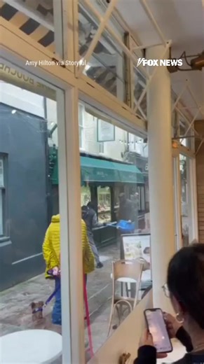 HIGH-END HEIST: Dramatic footage shows two masked robbers armed with a sledgehammer smashing through a London jewelry store window in broad daylight, grabbing multiple items from a display, and fleeing on foot. | Fox News