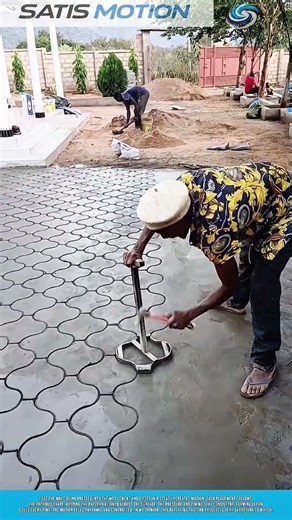 Pressing Pattern Mold Into Wet Cement Creating Repeating Tile Motion