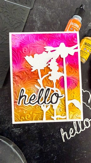 Ranger Ink (Official) on Instagram: "Bright color + bold texture = instant happy mail ✨ This fun HELLO card starts with @tim_holtz Silver Sparkle Cardstock and a splash of Tim Holtz Alcohol Inks in vibrant, feel-good hues. Once the sparkly panel was fully inked, @cheiron used an embossing folder to add that extra dose of shine and dimension. Texture makes everything better, especially sparkle! Perfect for turning a simple hello into something that really pops 💌 Supplies: Tim Holtz Alcohol Ink: