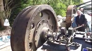 1920 Mirrlees Single Cylinder Blast injection diesel. After fitting the Flywheel and packing up the pedestal/outrigger bearing to take some of the weight of the flywheel it was time for the big test! Will it turn over? Here we have Ken with a relative short length of wood while Roger keeps his eye on the large end block to ensure it doesn’t come in to contact with the bedplate! | Anson Engine Museum