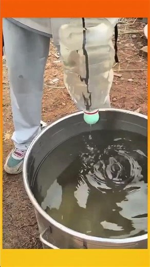 Water transferred using a reused plastic bottle fitted with a float, moving liquid efficiently
