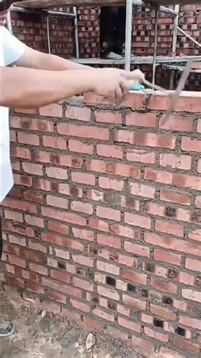 Installation of Red Bricks for Building Wall Construction