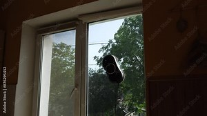 The hands of a professional repairman installing a plasterboard structure tightens a screw with a screwdriver.