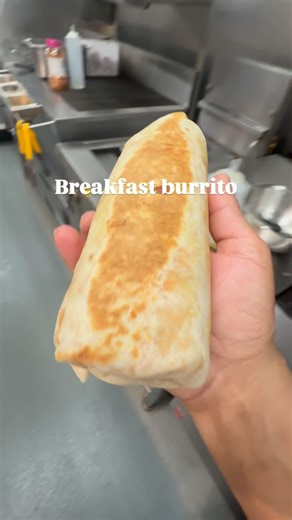 Breakfast Burrito 🌯! Ingredients ▶️ Tortilla wrap 1 pc ▶️Egg 2 pc ▶️Hash brown ▶️pickled onion ▶️salt ▶️black pepper ▶️guacamole ▶️spicy mayonnaise ▶️sour cream ▶️sliced tomato’s ▶️rice 20 gram ▶️mozzarella cheese 10 gram Instructions Start with cooking egg make it scramble add seasoning to it including rice once cooked well take it out . Take one tortilla wrap add cheese top of cheese add rice and egg mixture then hash brown tomato 🍅 all the sauces on top , make it roll and pan fried both sid
