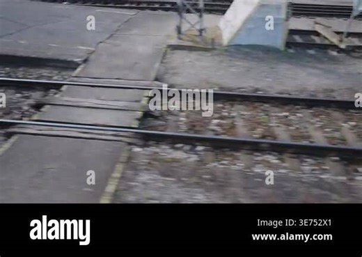 Passenger view from a moving express train looking at the railway tracks and concrete platform of a train station. High-speed travel Stock Video Footage - Alamy