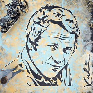 As a tribute to the original King of Cool, acclaimed artist Michael Kalish created a larger-than-life portrait of Steve McQueen. Rooting the portrait in authentic elements of McQueen’s life, the paint was spread on the canvas via motorcycle. A Bonneville T100 was ridden by Chase McQueen, grandson of Steve, over the canvas before Kalish pulled back layers to reveal the final stunning image of McQueen. | Triumph Motorcycles