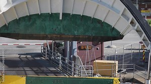 A bow visor of the passenger ferry lowers as the ferry departs from the Eide ferry terminal at Geiranger fjord.