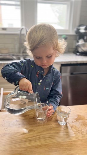 Pouring has been a favorite kitchen activity since he was a little over a year! We started with watering plants at 13 months (outside first then inside). This is a perfect starter pouring task because it’s a big target and if outside you don’t have to worry about mess. We then worked on pouring water and lots of spills later got that. Once he got that he became my pourer for all things in the kitchen! More recently he has been able to control the pour better and pour only to fill a glass rather 