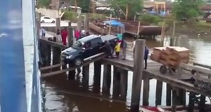 Truck driver boards ferry over plank 'bridge' (video)
