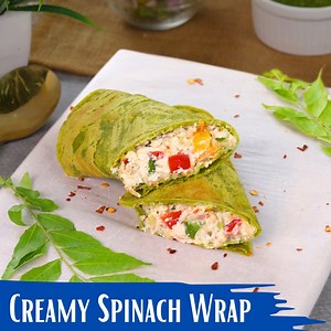 Ab ghar par banaiye ekdum creamy, cheesy aur healthy wrap jo banane mein super easy hai. Isme hai spinach, paneer, mixed veggies aur creamy filling jo aapke lunch box ya dinner ke liye perfect hai. Ingredients To Make the Wrap: ½ cup chopped spinach 1 cup gram flour ¼ cup curd 1 tbsp cucumber water 2-3 green chilies Salt to taste Water as required For the Filling: ¼ cup curd (thick) ¼ cup grated paneer 1 tbsp chopped red capsicum 1 tbsp chopped green capsicum 1 tbsp chopped onion ½ tbsp chopped 