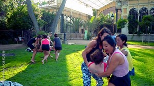 A group lesson on acroyoga master class which takes place on the lawn in the park. Slowmotion shot
