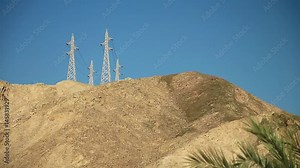 Overhead power line on the mountain. Power transmission towers