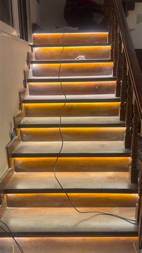 DESIGNS BY PALLAVI on Instagram: "Where craftsmanship meets ambience The staircase is coming alive with warm LED step lighting, enhancing both safety and mood while beautifully highlighting the natural wood finish. Paired with classic wooden balusters and elegant wall mouldings in soft pastel tones, this space is shaping into a refined yet welcoming transition zone. Every detail from lighting alignment to panel proportions is carefully executed to balance functionality with timeless aesthetics.�