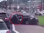 Moment police officer is dragged down by car driver in 'tactical stop'