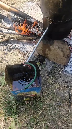 Outdoor Cooking Process with Open Fire and Large Pot
