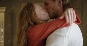 Attractive young couple making out kissing and sharing intimate moment hugging each other