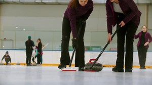 Female curling players in a shot close to the ice - Free Stock Video