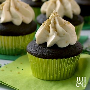 Celebrate St. Patrick's Day with these chocolate Guinness cupcakes that are topped with an Irish cream frosting. ☘️💚 Bonus: there is a festive surprise hiding inside! RECIPE: http://bit.ly/2NUeNio | Better Homes & Gardens