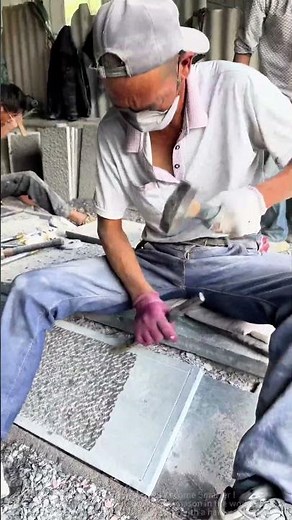 “Master Stonecrafter's Art: Chiseling Textured Patterns with Hammer and Tool”