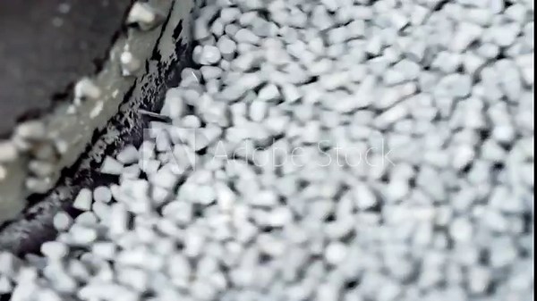 Handling plastic granules in production.
