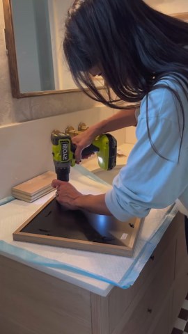 Abby Kulp DIY | DESIGN on Instagram: "DIY Hidden Medicine Cabinet!!! I LOVE that I can hide toilet paper behind framed art. 來 This was a super simple build using scrap wood, a picture frame I already had and a piano hinge. I will definitely be building more of these in the future.  Head to my story highlights for more details! #bathroomdecor #bathroomstorage #secret #storage #cabinet"