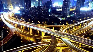 Timelapse of freeway busy city rush hour heavy traffic jam highway Shanghai at night,Yan'an East Road Overpass interchange,the light trails of traffic with super long exposures,urban building.