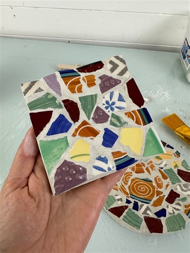Here's a quick tutorial on how we made our broken china mosaic coasters! This was a fun beginner basic project if you have been wanting to try this type of mosaic yourself. ✨ You will need: A square wood base craft knife Craft glue/water (for sealing) ***Saftey glasses and gloves Mask (for sanding and mixing grout) Broken plates- I got mine cheap from the thrift store, but this would be a great opportunity to upcycle any broken plates or cups you had in your kitchen too! Hammer or tile nippers Z